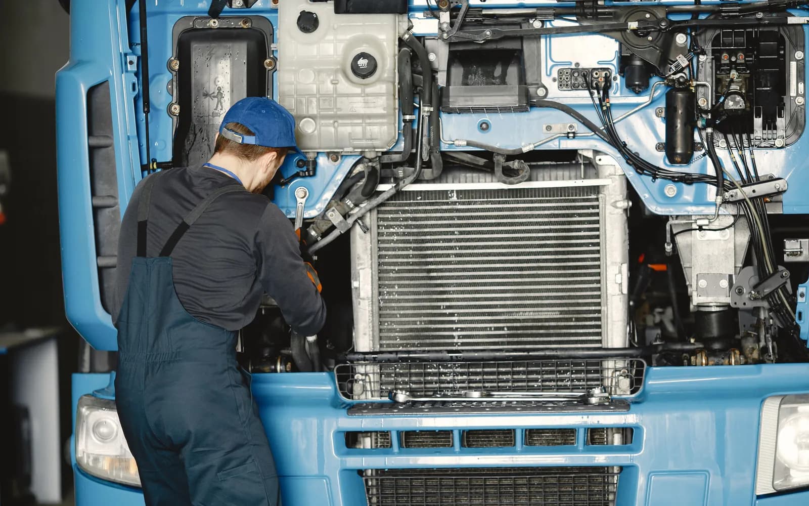 Technician working on an engine in a workshop: illustrative image